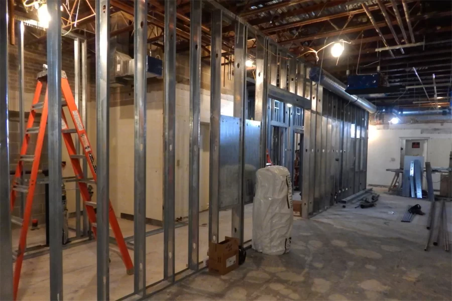 Metal wall studs delineate the new location of restrooms on Dana's first floor. With the elevator at the approximate center of the space behind the studs, handicapped facilities will be built to the left and general-use facilities to the right. (Doug Hubley/Bates College)