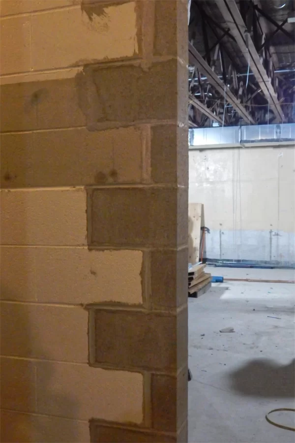 An example of masonry toothing, with new concrete blocks filling out the toothed edge of a newly cut doorway. (Doug Hubley/Bates College)