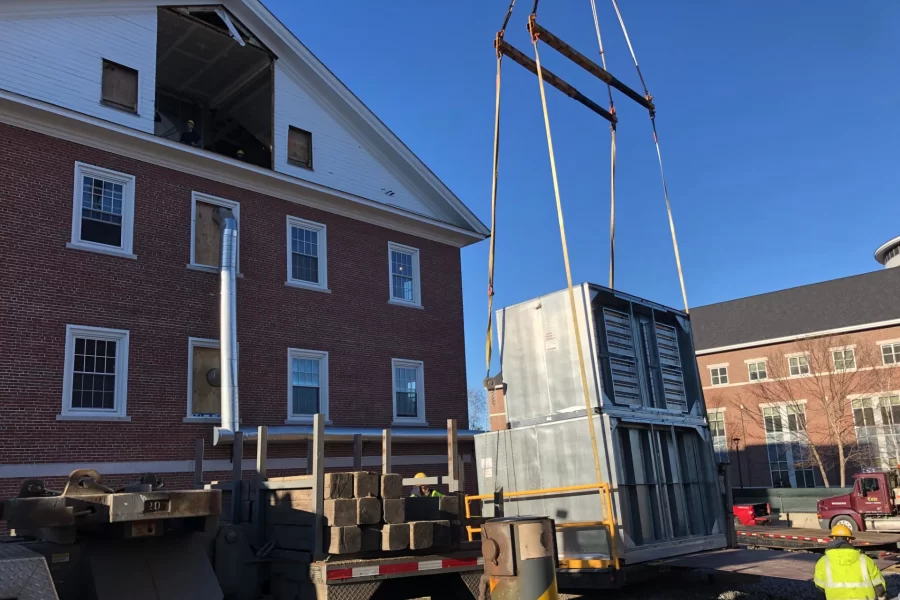 A crane picks one part of the new HVAC machine going into Dana Chemistry Hall on Nov. 29, 2021. The machine has seven parts that were hoisted into the attic during the day. (H. Jay Burns/Bates College)