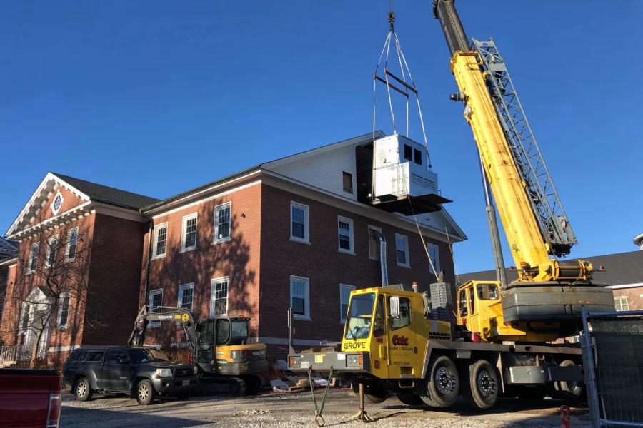 A piece of the new HVAC machine nears the opening in the Dana Chemistry Hall attic. (H. Jay Burns/Bates College)