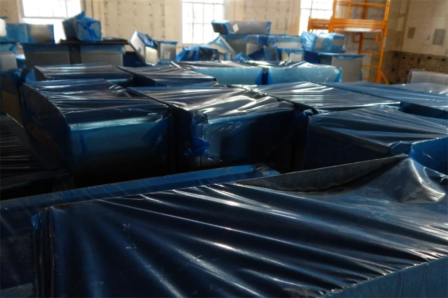 Plastic-protected air ducts and fan-coil units are stored in a Dana Chem classroom. (Doug Hubley/Bates College)