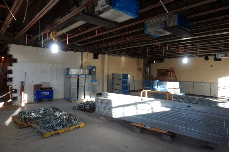 Pipe hangers on pallets, wall studs on a cart, and HVAC components stockpiled in a third-floor classroom. (Doug Hubley/Bates College)