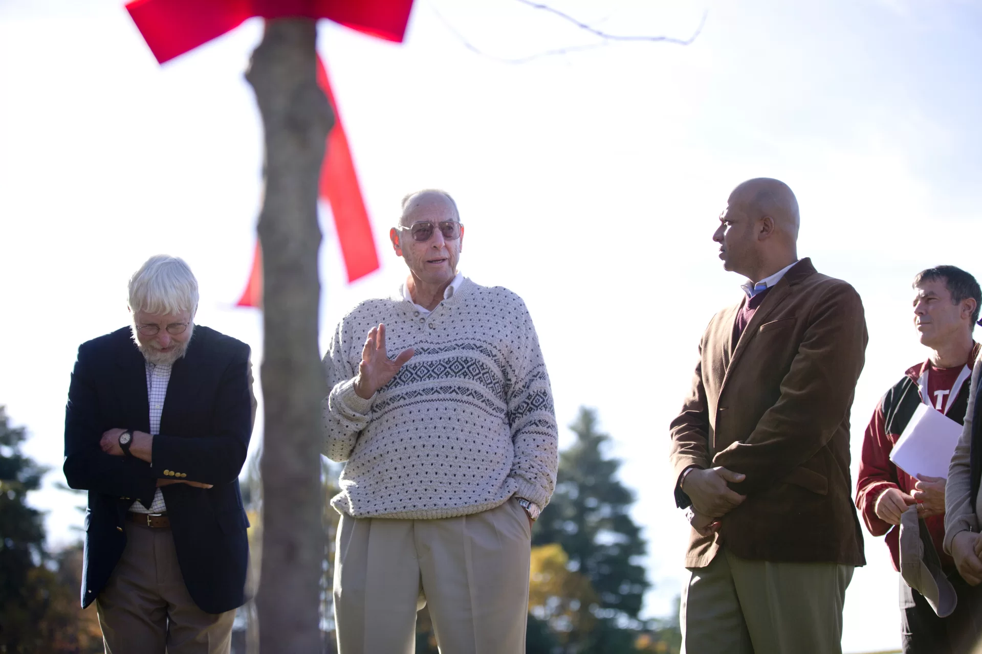 Herb Bunker Memorial Celebration
A tree planting ceremony was held in honor of former Bates squash coach Herb Bunker, the founder of the Bates College squash program. Those in attendance included Kevin McHugh, director of athletics; Pat Cosquer '97, head coach of men's and women's squash; members of the men's and women's squash teams, and George Wigton. Wigton served Bates College from 1965 until his retirement in 1996. During that time he was Bates’ longest serving coach of men’s basketball (20 years), and at 26 years the longest serving coach of men’s tennis. He coached men’s soccer and women’s tennis. He was instrumental in bringing squash to Bates, and served as head coach for men’s and women’s squash. For the 10 years between 1974 and 1984 he was Assistant Director of Athletics. Also present were attorney Jon Oxman (in blue blazer; Jo Bunker, Herb's widow; Art  Bull '88, president of the Bates Squash Club in 1985-86; his wife Lisa Bull '87, and their son, Jack, 13.