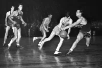 Ernie Calverley (3), Rhode Island State center, and Wallace Jones, right, Kentucky center, go into high gear attempting to take possession of a free ball in the second period of the final game of NIT at Madison Square Garden in New York, March 21, 1946. Calverley was named MVP in the tournament but his team lost the final game to Kentucky, 46-45. (AP Photo/Matty Zimmerman)