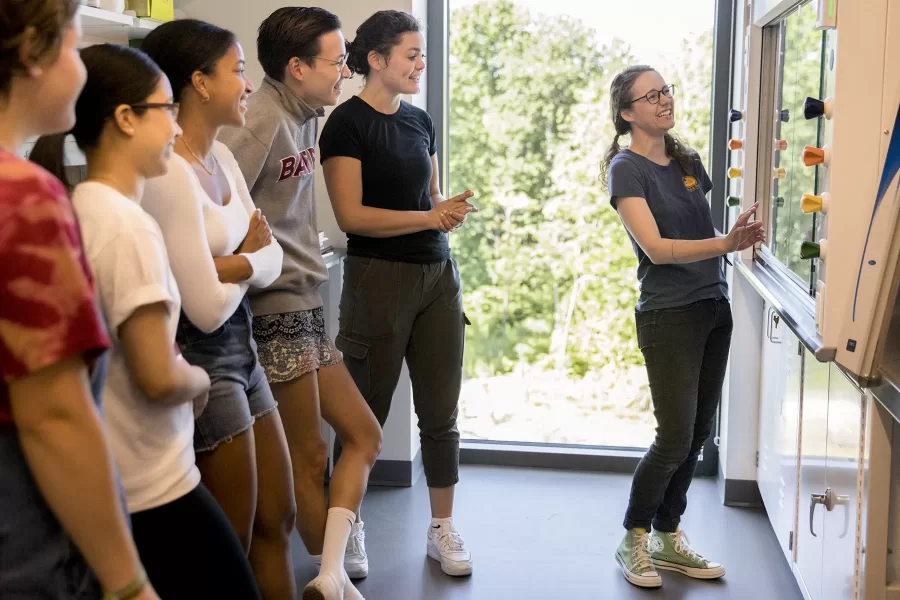 Assistant Professor of Chemistry and Biochemistry Colleen O’Loughlin explains the features of the new fume hood in her Bonney Science Center laboratory to her student researchers on June 24, 2021. (Phyllis Graber Jensen/Bates College