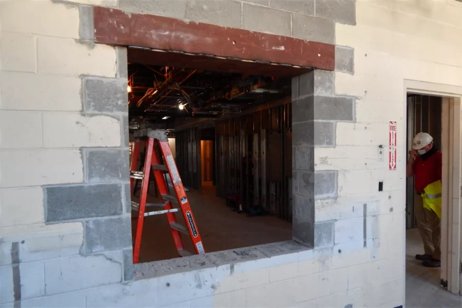 Masons are pretty much done with so-called block infill in Dana Hall — that is, using concrete blocks to fill unwanted holes and fill out the borders of new openings. Capped with a new steel lintel, this opening will give students using a new writeup room a view of the third-floor lobby. (Doug Hubley/Bates College)