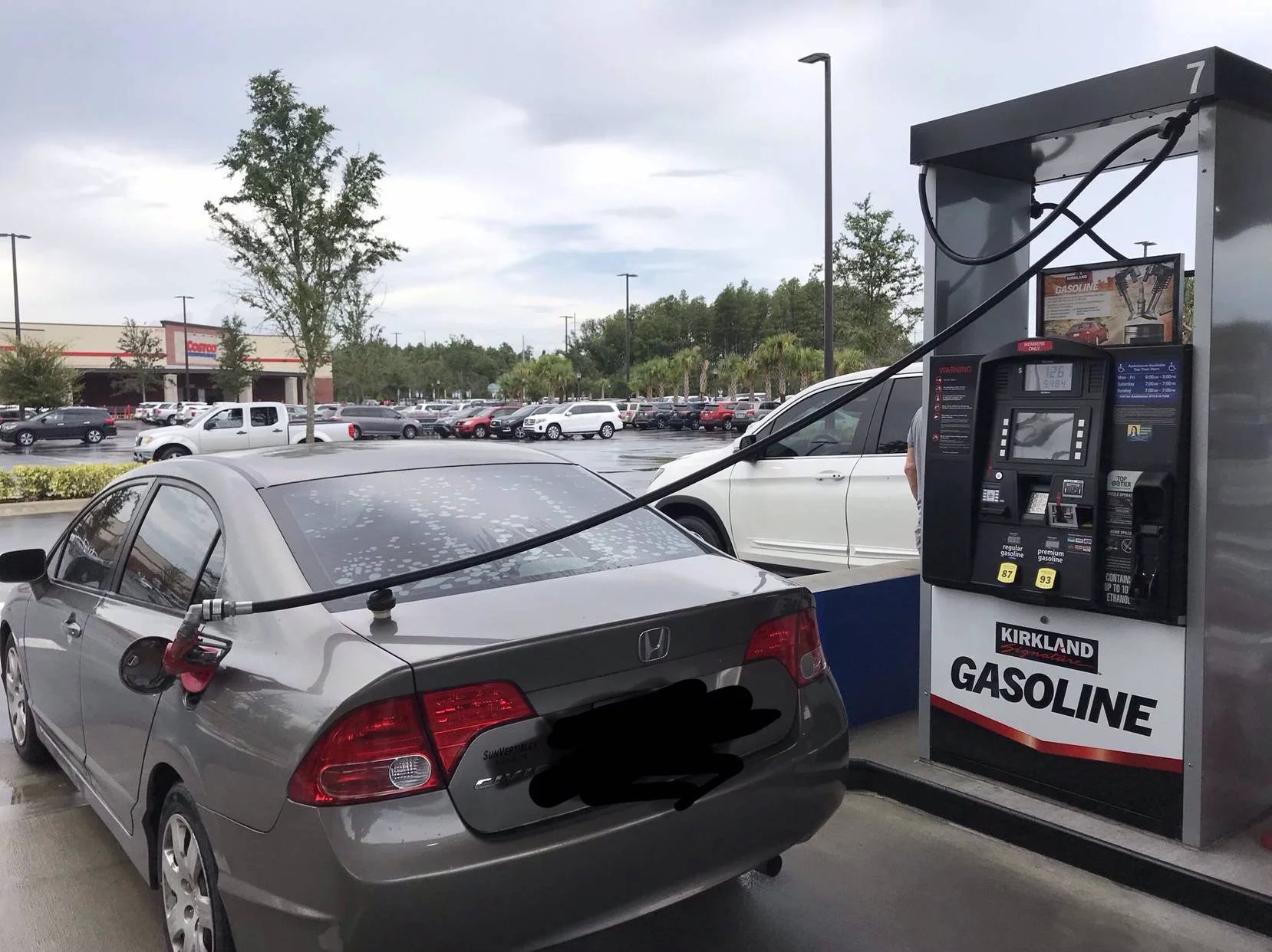 Reddit user ministerman posted this photo of a car with the license plate obscured to demonstrate the extra length of the pump hoses at Costco gas stations.