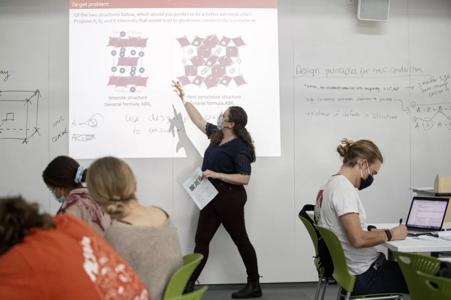 During a class session in October 2021 for the course “Advanced Topics in Inorganic Chemistry,” Assistant Professor of Chemistry and Biochemistry Geneva Laurita used the expanse of whiteboard and a projector. (Phyllis Graber Jensen/Bates College)