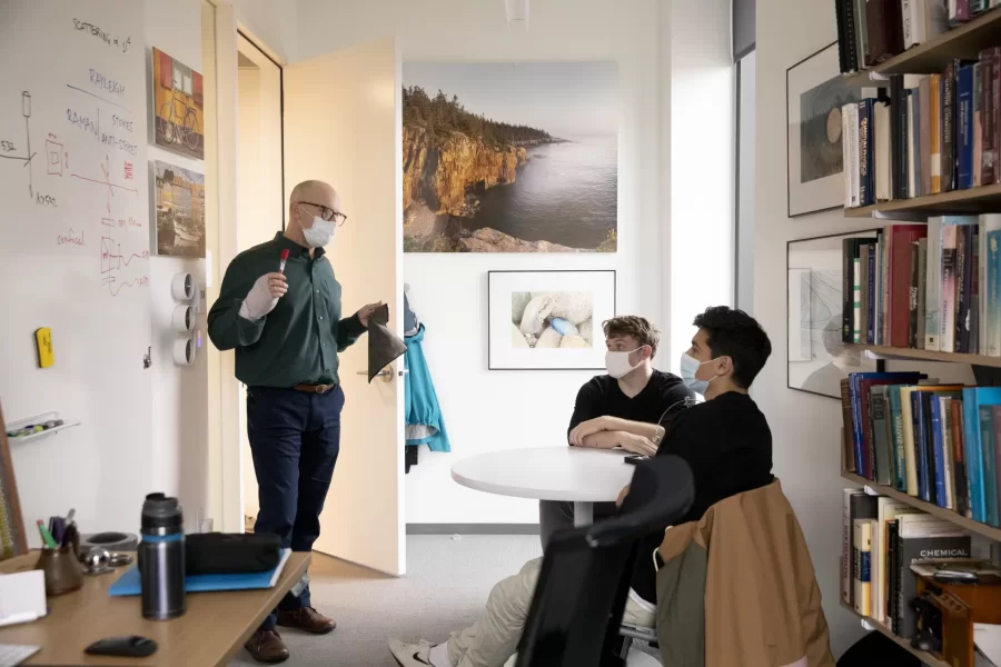 Associate Professor of Physics Matt Côté (left) meets with two of his senior thesis students, Chris Dye (center) of Windham, Maine, and Seren Parikh of Bedford, Mass. (Phyllis Graber Jensen/Bates College)