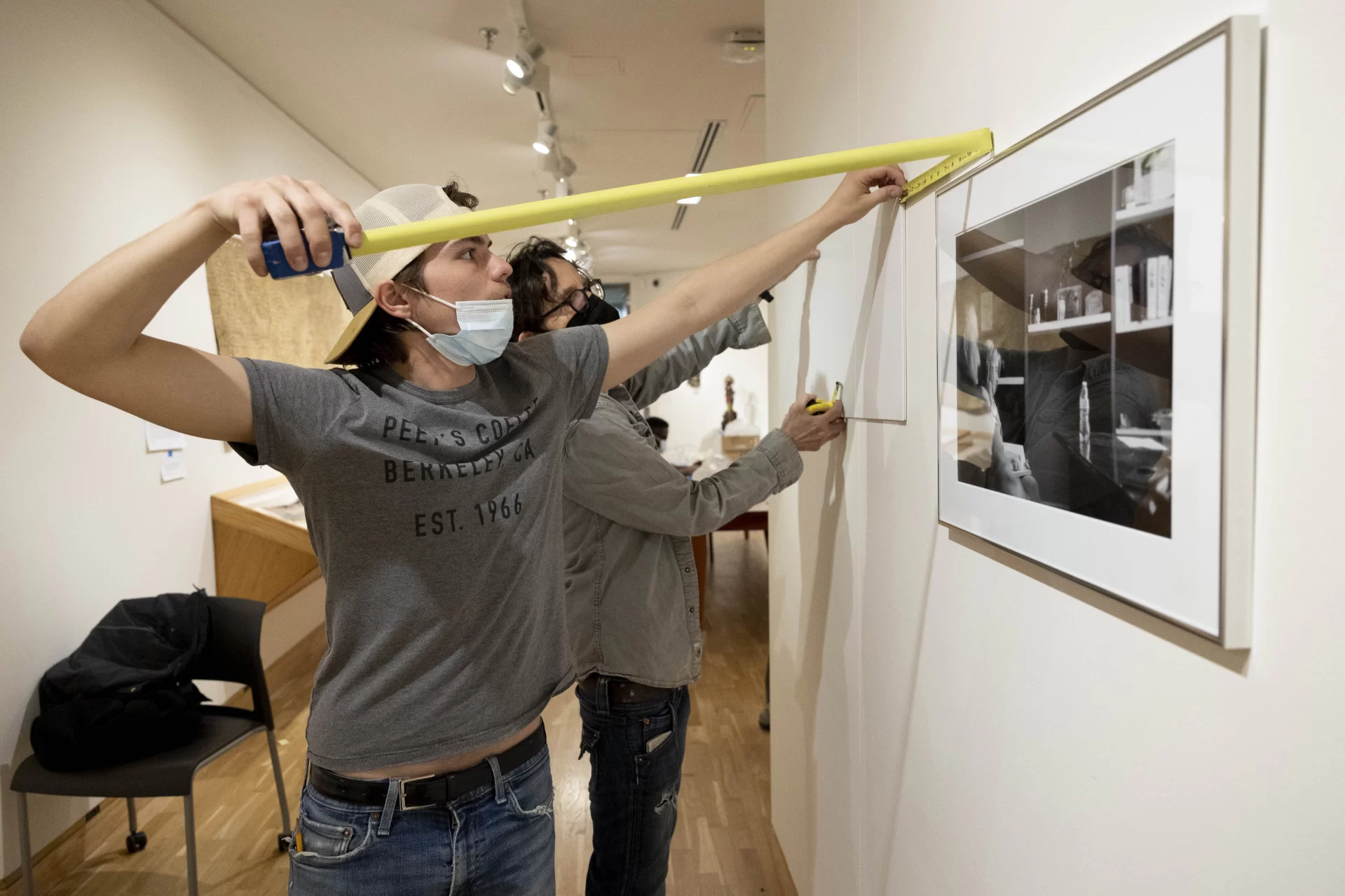 Studio art majors from the Class of 2022 begin to install their senior thesis exhibition in the Bates College Museum of Art with the help of their faculty adviser Elke Morris and museum staffers staffers Michel Droge, in grey long-sleeved shirt, and George Walsh, in green t-shirt.

Students shown are seniors Ollie Penner of Pasadena, Calif.,  in green collared shirt, Anna Gouveia of Jenkintown, Pa., in purple pants, John Ryan with dark sweater and John Loftus of Palo Alto, Calif.,in baseball cap.