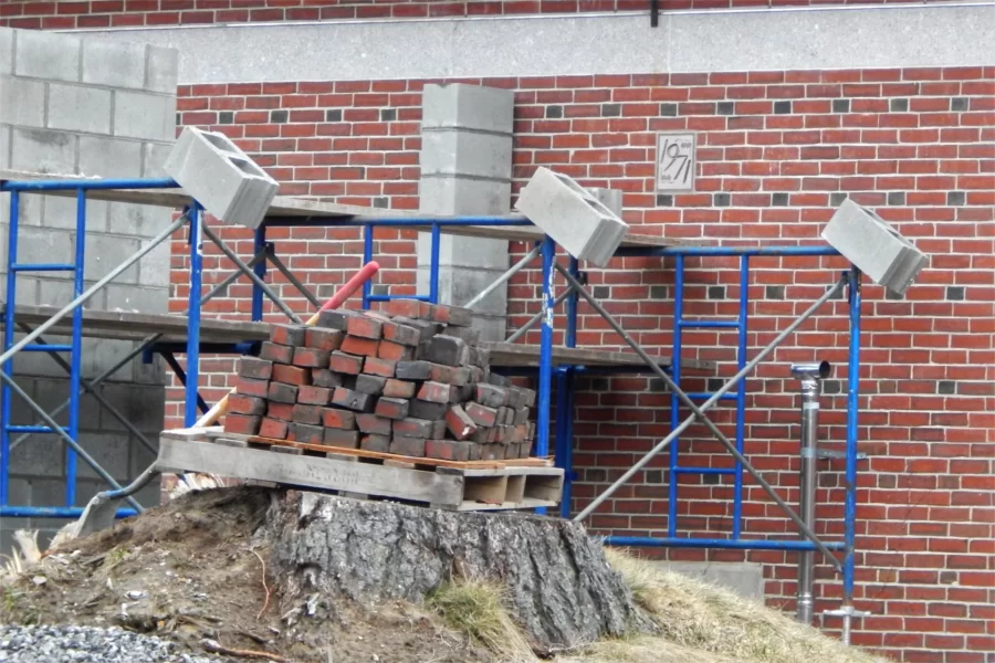 An artist's pallet: Composition in masonry near the future site of an HVAC water chlller at Dana Hall. Note the 1971 ivy stone to the right of center. (Doug Hubley/Bates College)