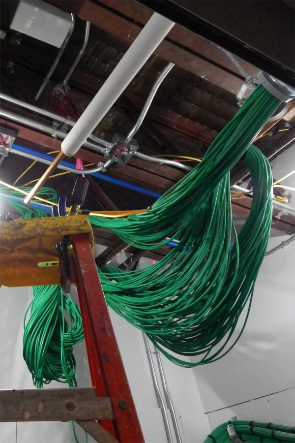 Green data cables are bundled in a first-floor information technology closet. (Doug Hubley/Bates College)
