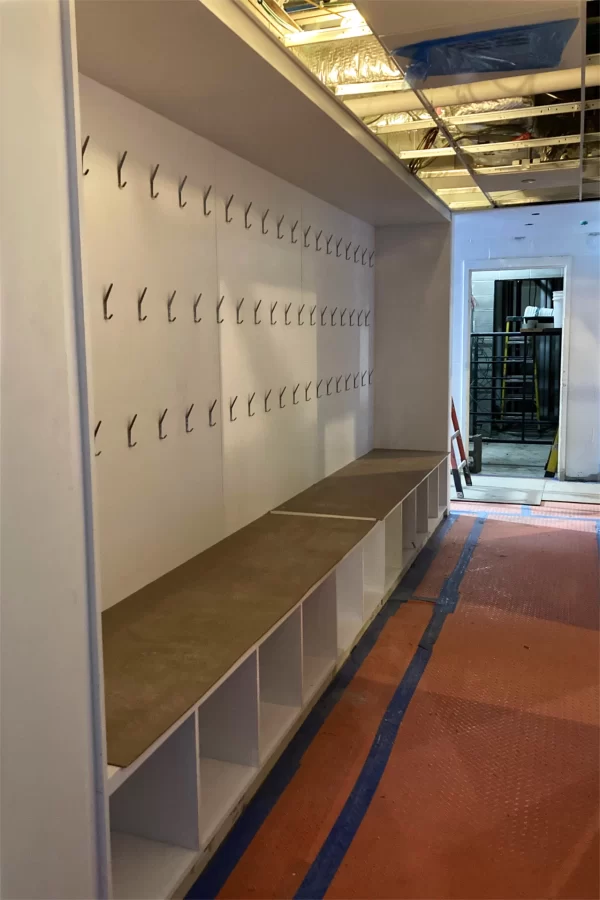 Coathooks and cubbies for student use are among the built-in furnishings broadly known as casework. Shown is the corridor giving access to second-floor restrooms. (Doug Hubley/Bates College)