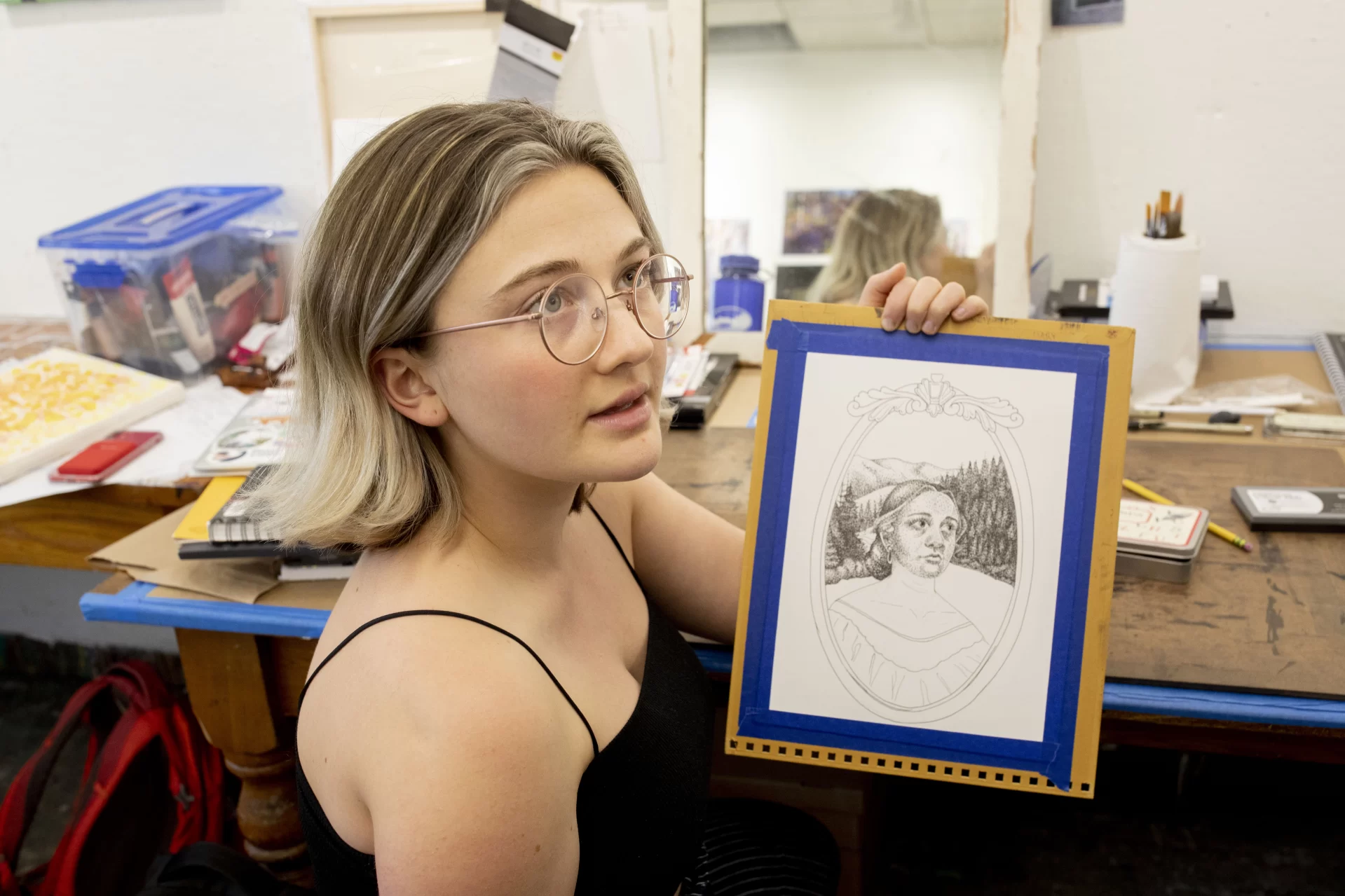 Art and visual culture majors with a studio concentration work in their first-floor Olin Arts Concert Hall studios in preparation for the Annual Senior Exhibition that will open in April at the Bates College Museum of Art.

Emily Graumann ’22 (in gray sweater) of Salem, a double major in AVC and English, is producing a thesis in hand-drawn animation.

Ollie Penner  ’22 (purple shirt) of Pasadena, Calif,, is a double major in AVC and American Studies, whose thesis uses photography and Photoshop.

Kathy Boehm ’22 (black sweater) of Denver, Colo.,  is a double major in AVC and American studies, who’s designing town with  drawings and mixed media.

Mary Richardson ’22 (black tank top) of Blue Hill, Maine, is a double major in AVC and psychology and exploring themes of growing up and bodily image. She’s using mixed media and colored pen.