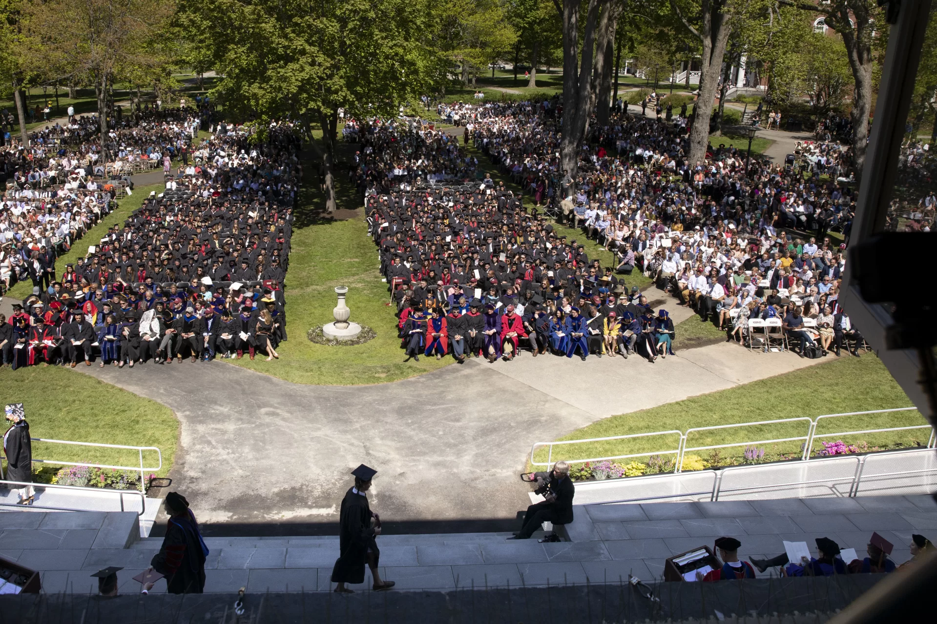 Bates College 2019 Commencement  (the one hundred and fifty-third) on the Historic Quad, at which Travis Mills receives an Doctor of Humane Letter. Placing the collar on Mills is the college's mace bearer, Charles Franklin Phillips Professor of EconomicsMichael Murray.