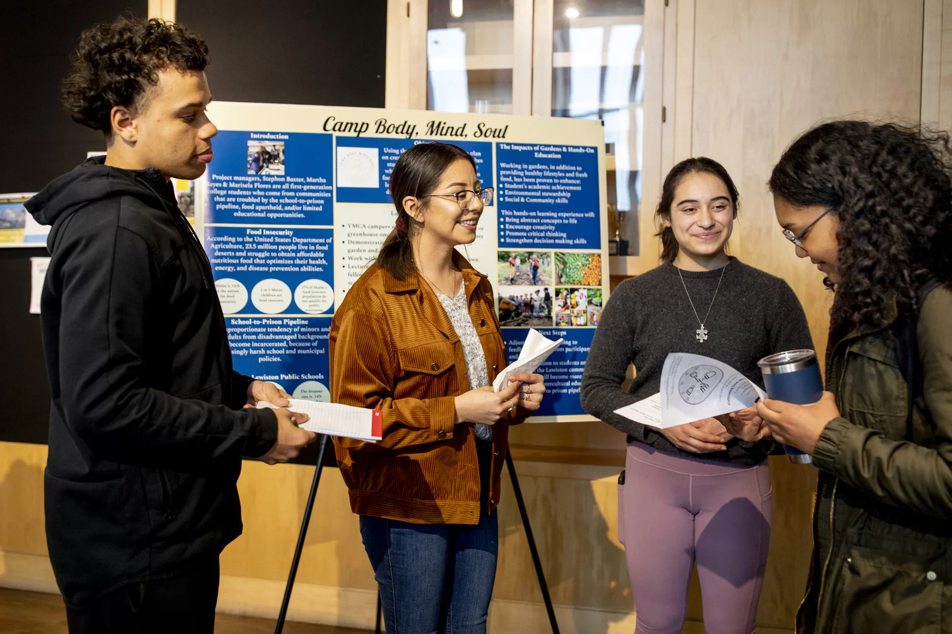 “I came to look and ask questions..— History major Ursula Rall ’20, right, attends an informal presentation by Stephon Baxter ‘23, Marisela Flores Pineda ’23, and Martha Reyes ‘23