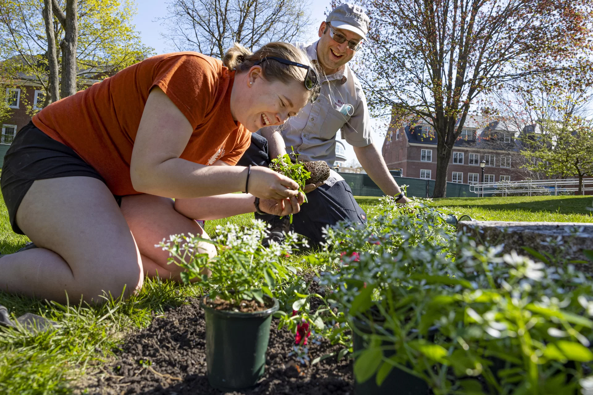 Grounds & Maintenance Lead - Horticulture Focus Jeremy Lavertu  and Charlotte Collins ’22 (of Woolwich, Maine, plant around the sundial in front of Coram Library on the Historic Quad, beautifying the area in preparation for Commencement 2022.