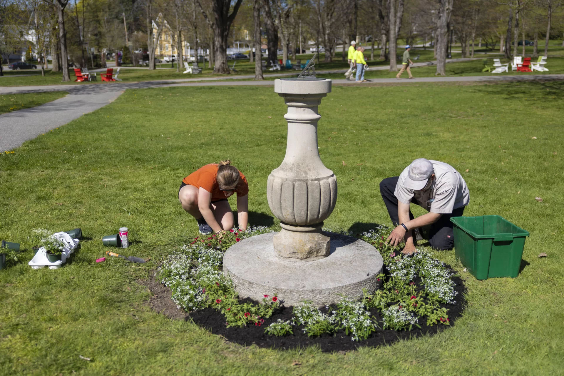 Grounds & Maintenance Lead - Horticulture Focus Jeremy Lavertu  and Charlotte Collins ’22 (of Woolwich, Maine, plant around the sundial in front of Coram Library on the Historic Quad, beautifying the area in preparation for Commencement 2022.