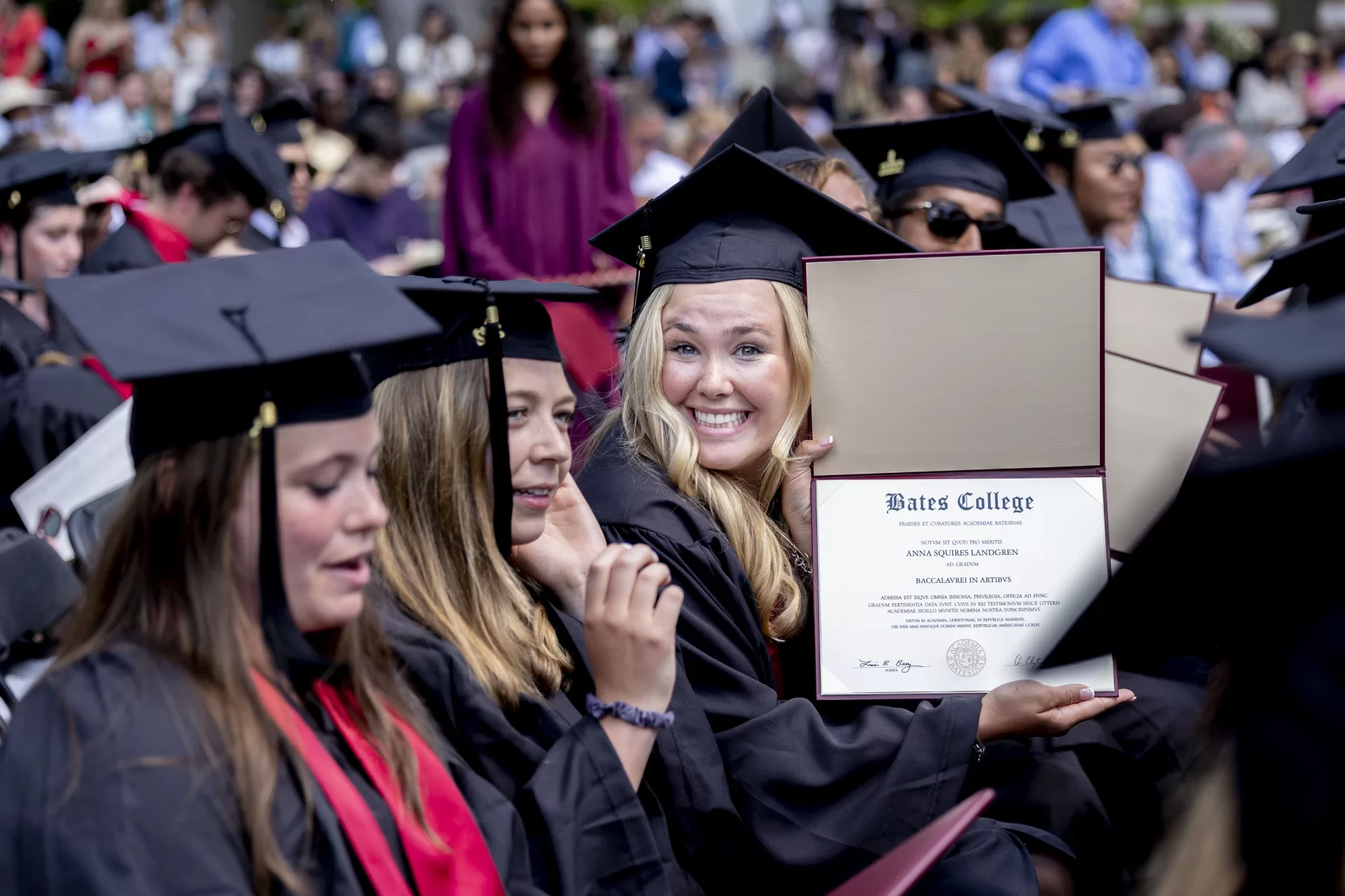 Anna Landgren '22 brandishes her diploma at Commencement on May 29, 2022. (Phyllis Graber Jensen/Bates College)