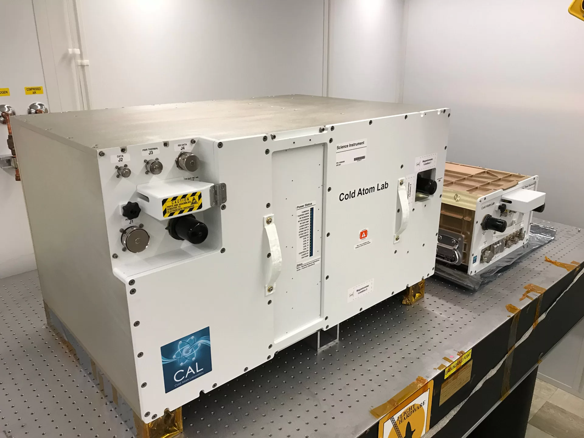 Seen before its 2018 launch to the International Space Station the Cold Atom Laboratory comprises two containers that larger of which contains the lab's "physics package," where experiments requested by Bates physicist Nathan Lundblad on ultracold atoms takes place. (Photograph courtesy of the Jet Propulsion Lab)