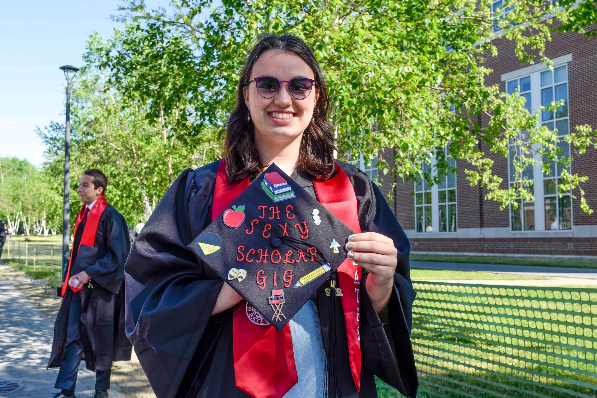 Graduates of the Class of 2022 walked in style at Bates College's 156th Commencement on May 29, 2022, with decorated caps, stoles, and other accessories.

Zane Rahabi ’22, (Lord of the Rings meme) Geology major, mathematics minor, Westwood, Mass.

Rebekah Vaules, ("Up" schoolhouse) French and Francophone studies major, Education, religious studies minors, Pittsford, N.Y.

Olivia Dimond, ("the sexy scholar gig") Theater major, education minor, Henrico, Vir.

Daniah Foster, (pink and gold glitter and flowers) American studies major, anthropology minor, Shelton, Conn.

Rachel Retana, (Mexican loteria board) Politics, gender and sexuality studies majors, African American studies minor, Chicago, Ill.

Adama Diaby, ("pretty, educated & graduated") politics major, history minor, New York

Janell Sato, (haku lei with red roses and raffia) biology major, religious studies minor, Honolulu, Hawai’i

Isabella David, ("keep moving forward") politics major, rhetoric, film, and screen studies minor, East Elmhurst, N.Y.

Jenniflore Beaubrun, (flowers on side and red ribbons) mathematics major, African American studies and digital and computational studies minors, Hyde Park, Mass.

Alex Teplitz, (googly eyes) English major, gender and sexuality studies minor, he/they, New York

Ojochenemi Maji, (daisies and butterflies on cap, nails, and stole) geology major, digital and computational studies minor, Nigeria