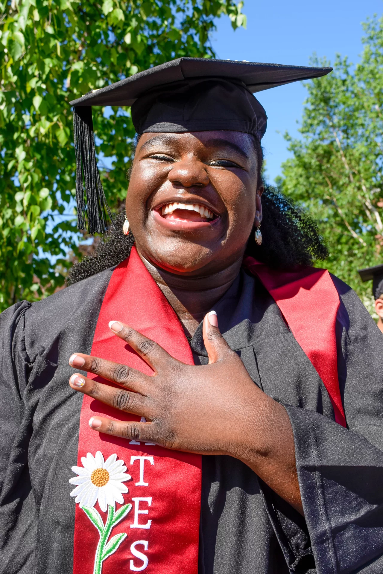 Graduates of the Class of 2022 walked in style at Bates College's 156th Commencement on May 29, 2022, with decorated caps, stoles, and other accessories.

Zane Rahabi ’22, (Lord of the Rings meme) Geology major, mathematics minor, Westwood, Mass.

Rebekah Vaules, ("Up" schoolhouse) French and Francophone studies major, Education, religious studies minors, Pittsford, N.Y.

Olivia Dimond, ("the sexy scholar gig") Theater major, education minor, Henrico, Vir.

Daniah Foster, (pink and gold glitter and flowers) American studies major, anthropology minor, Shelton, Conn.

Rachel Retana, (Mexican loteria board) Politics, gender and sexuality studies majors, African American studies minor, Chicago, Ill.

Adama Diaby, ("pretty, educated & graduated") politics major, history minor, New York

Janell Sato, (haku lei with red roses and raffia) biology major, religious studies minor, Honolulu, Hawai’i

Isabella David, ("keep moving forward") politics major, rhetoric, film, and screen studies minor, East Elmhurst, N.Y.

Jenniflore Beaubrun, (flowers on side and red ribbons) mathematics major, African American studies and digital and computational studies minors, Hyde Park, Mass.

Alex Teplitz, (googly eyes) English major, gender and sexuality studies minor, he/they, New York

Ojochenemi Maji, (daisies and butterflies on cap, nails, and stole) geology major, digital and computational studies minor, Nigeria