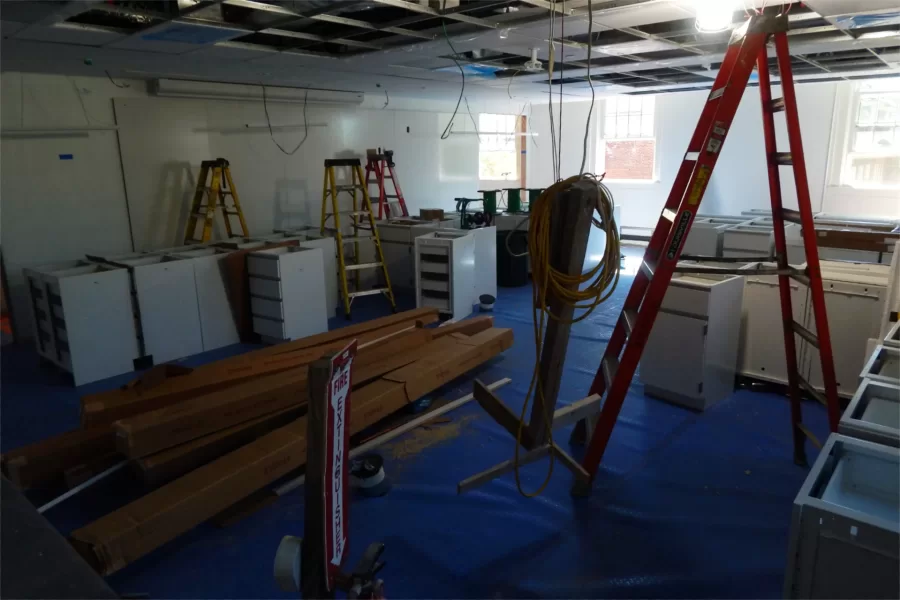 Lab benches and other casework are stockpiled in a classroom on Dana Hall’s second floor awaiting installation. (Doug Hubley/Bates College)