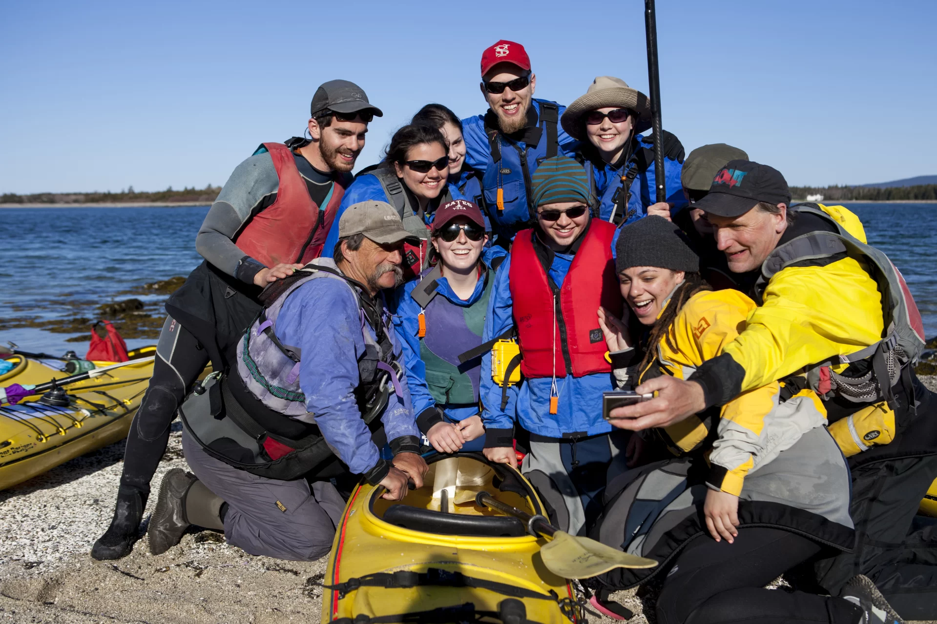 Dyk Eusden's Geology of the Maine Coast by Sea Kayak class takes a "selfie" on Little Cranberry Island before paddling to Great Cranberry Island to begin geology work.(Sarah Crosby/Bates College)