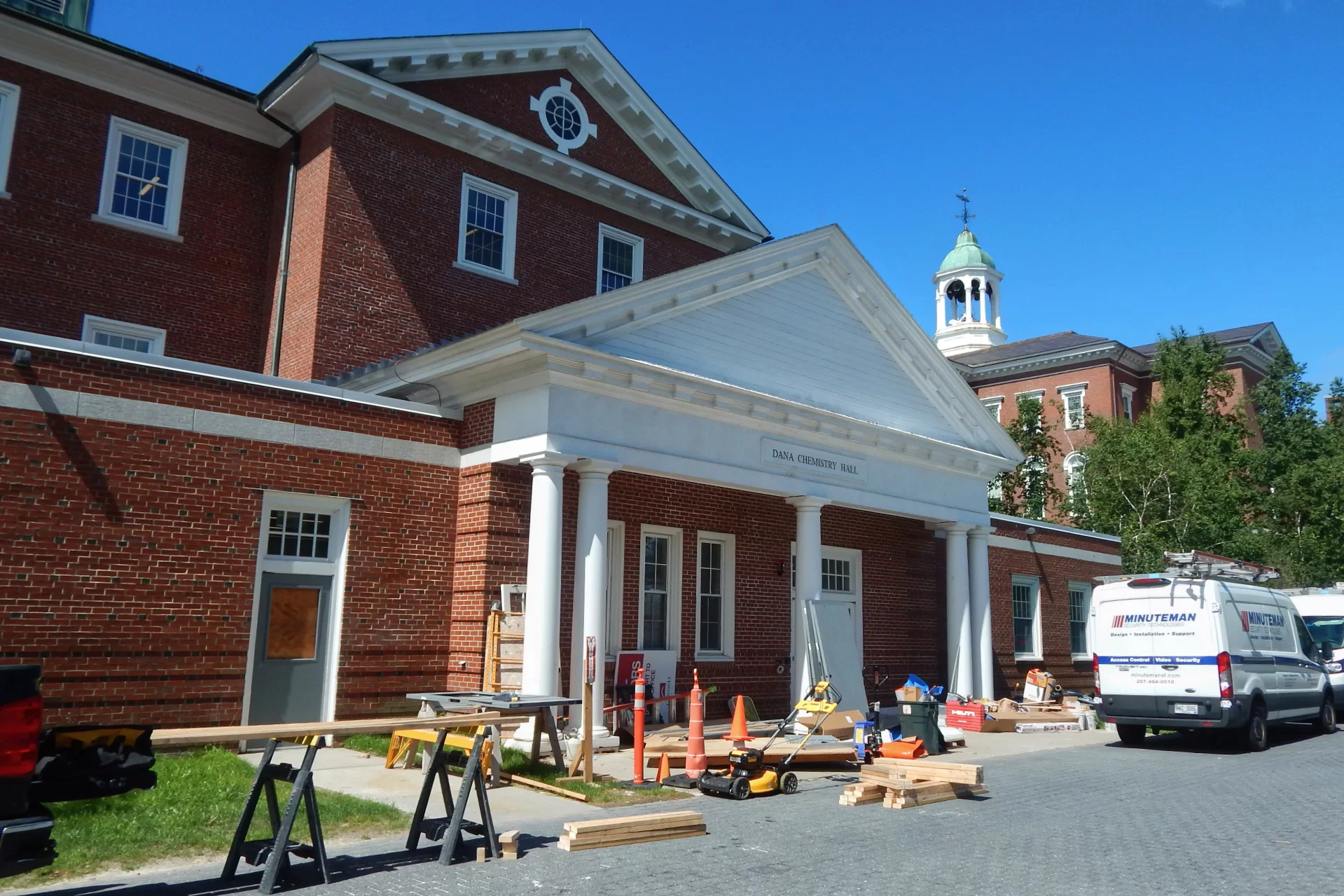 While the Historic Quad side of Dana Hall is an oasis of quiet and shade, there's still construction action along Alumni Walk. (Doug Hubley/Bates College)