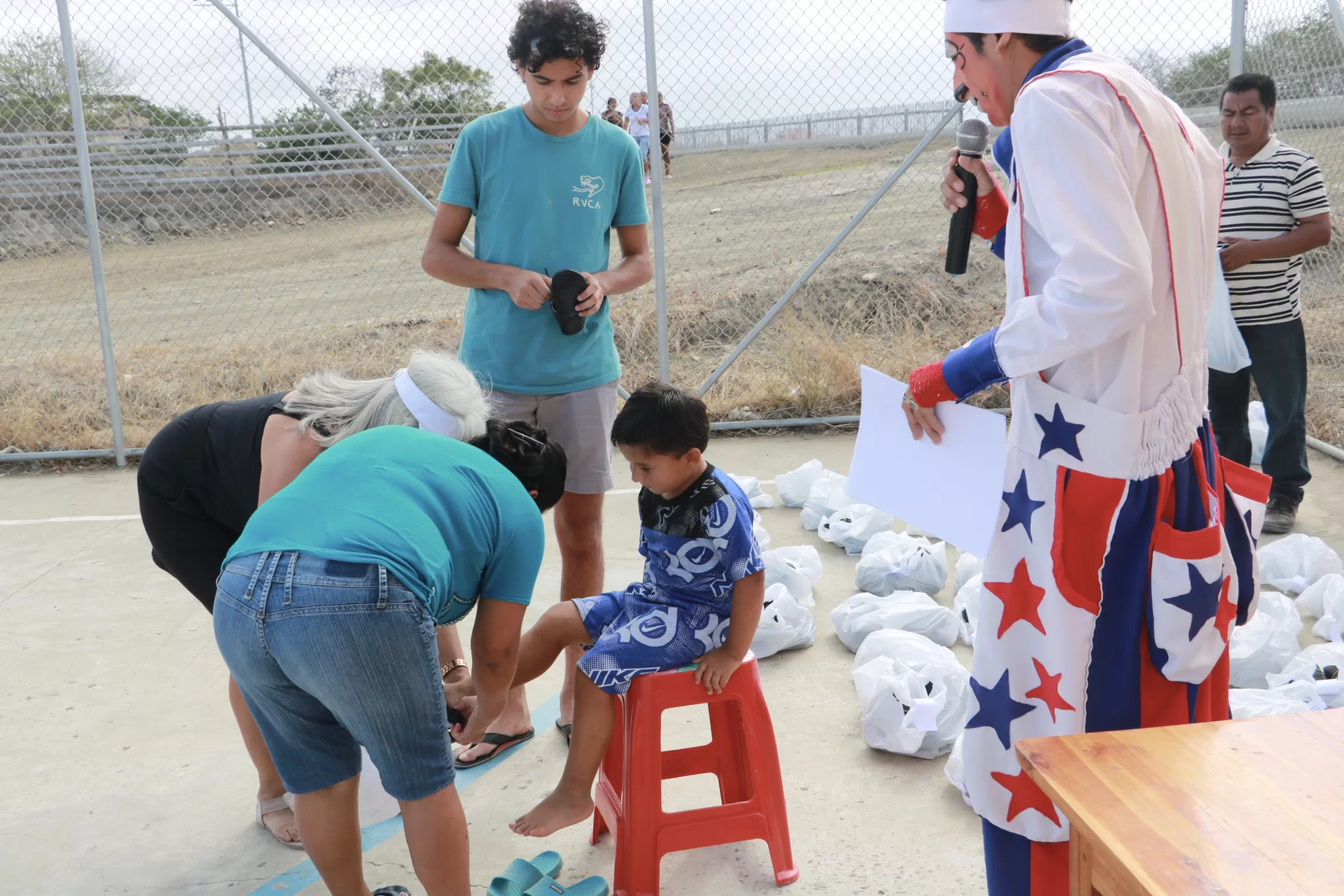 Ramiro Davila '25, standing in center, partnered with The Shoe That Grows for the first time in 2019, when he helped distribute 100 pairs of shoes to La Travesia, a rural community in Manta, Ecuador. (Photo courtesy of Ramiro Davila)