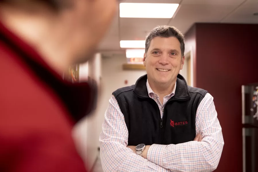 From left, H. Jay Burns, BCO Editorial Director and Bates Magazine Editor, chats with Eric Foushee, Associate Vice President for College Advancement in a BCO hallway in Lane Hall.