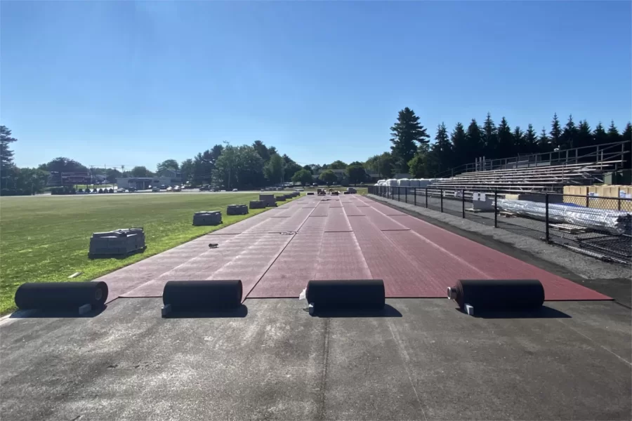 Placement of the new Mondo surface on the Russell Street Track was well underway by the morning of July 28. (Paul Farnsworth/Bates College)