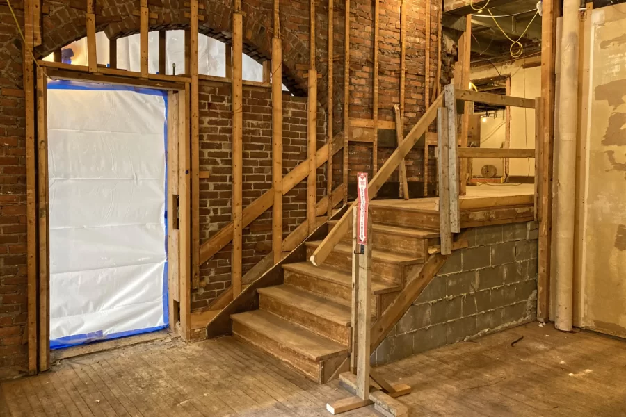 Situated at the east end of Chase Lounge, this space will be hard to recognize after the Chase Hall renovation. The single door into the lounge will be replaced by double glass doors, and the stairs will become a ramp leading to a landing for a new stairway and elevator. (Doug Hubley/Bates College)