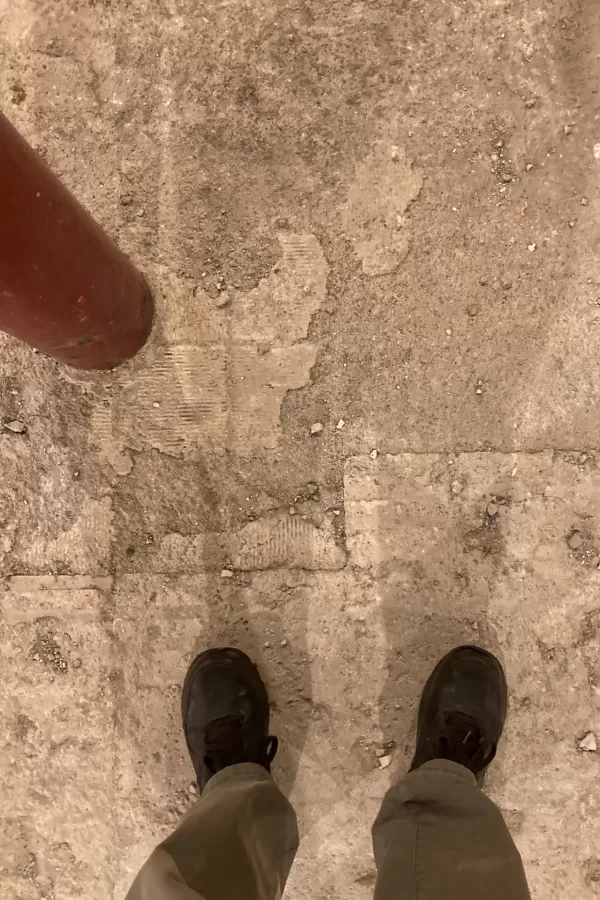 When floors collide: Two different types of floor surface, built at different times, meet at this site of a future rest room. (Doug Hubley/Bates College)