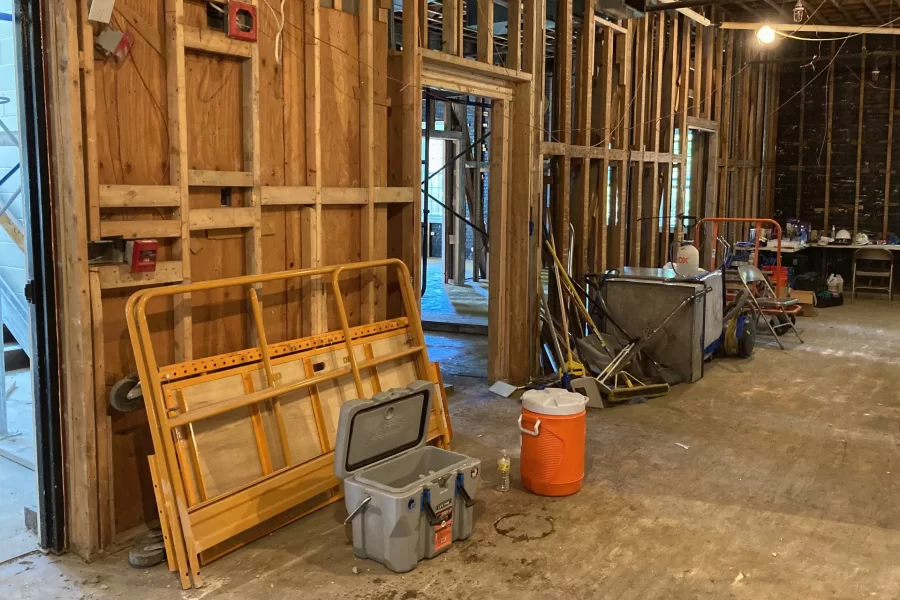 Bereft of wall, ceiling, and floor coverings, Chase Hall’s first-floor lobby hardly looks like itself. (Doug Hubley/Bates College)