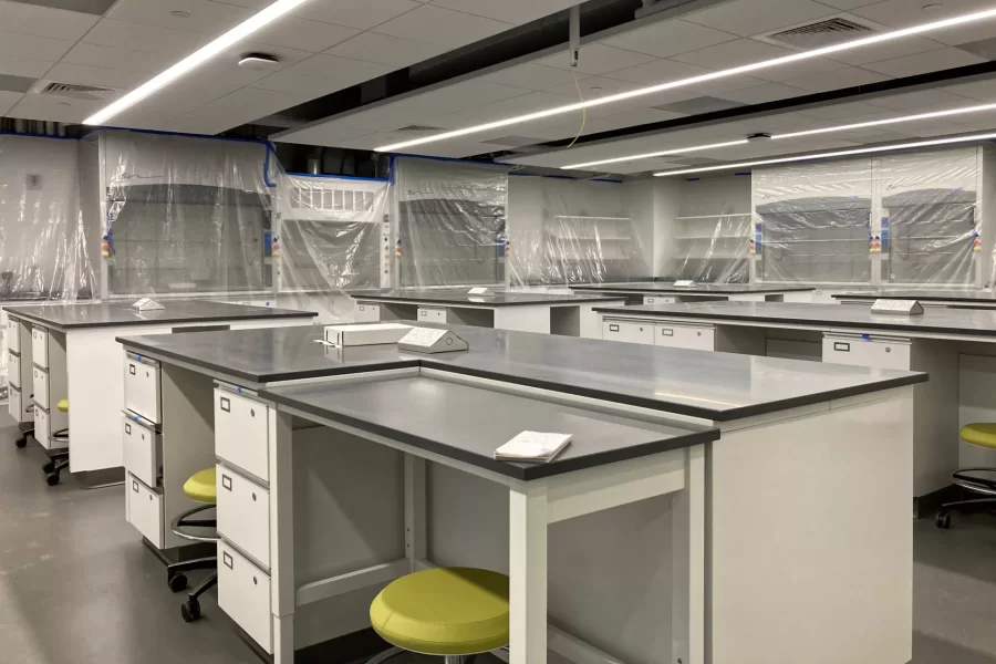 Dana 119 is an introductory chemistry lab. The temporary plastic film on the fume hoods keeps out dust and other contaminants. The rod projecting from the ceiling is the mount for a projector. (Doug Hubley/Bates College)