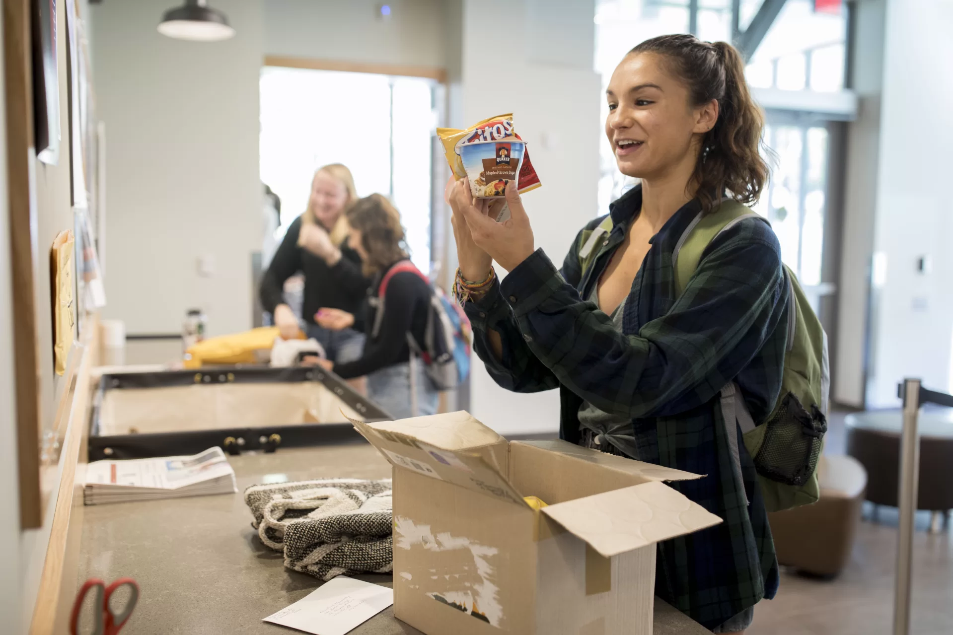Students pick up packages at Post and Print in Kalperis Hall, 65 Campus Ave.


Libby Masalsky '18 of Warwick, R.I., opens up a care package from her grandmother who sends her a monthly package. This one included snacks, a necklace, clothing, a Halloween card, and cash.