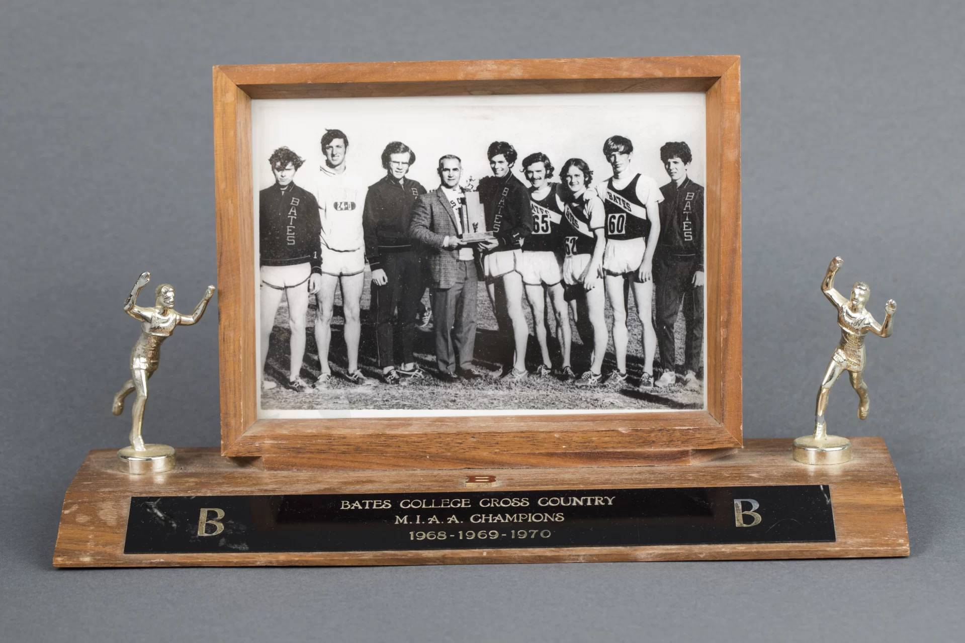 Objects from the Edmund S. Muskie Archives, photographed in the BCO studio at 141 Nichols Street, on July 19, 2018.

Trophy, Bates College Cross Country M.I.A.A. Champions, 1968, 1969, 1970; has attached framed photograph of the
team and Coach Walt Slovenski. 12 in. x 4 in. x 7 in.

Drawer
11 37