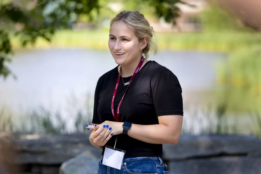 Sam Simmons ’24, a neuroscience major from Louisville, Ky., gives a one-hour campus tour on a warm summer afternoon, getting to know a group of adults, and they her, as their prospective students see Bates in a separate walk-through.
“It’s something special about Bates tours and Admissions,” she says of the custom of separating high school students and their parents. It’s a great opportunity for the students to ask questions that they wouldn’t want to ask around their parents and vice versa.”
Simmons, an Admission summer intern, gave her first campus tour in June — you’d never know she’s a newbie as she skillfully walks backwards, and weaves personal anecdotes with institutional wisdom without missing a beat. She’s also staffing information sessions and participating on the social media committee for the Class of 2026 Instagram account.
She enjoys tailoring the walks and talks to the interests of the visitors so that she can point out specific buildings or spots they might be particularly interested in. She thinks tours are great, but “simply being on campus makes a difference. If students can picture themselves sitting in Commons as she did on her high school visit, or walking to the library, “I think it’s the best way to figure out if they want to go to school here, if they can actually see themselves as a member of the Bates community.”
