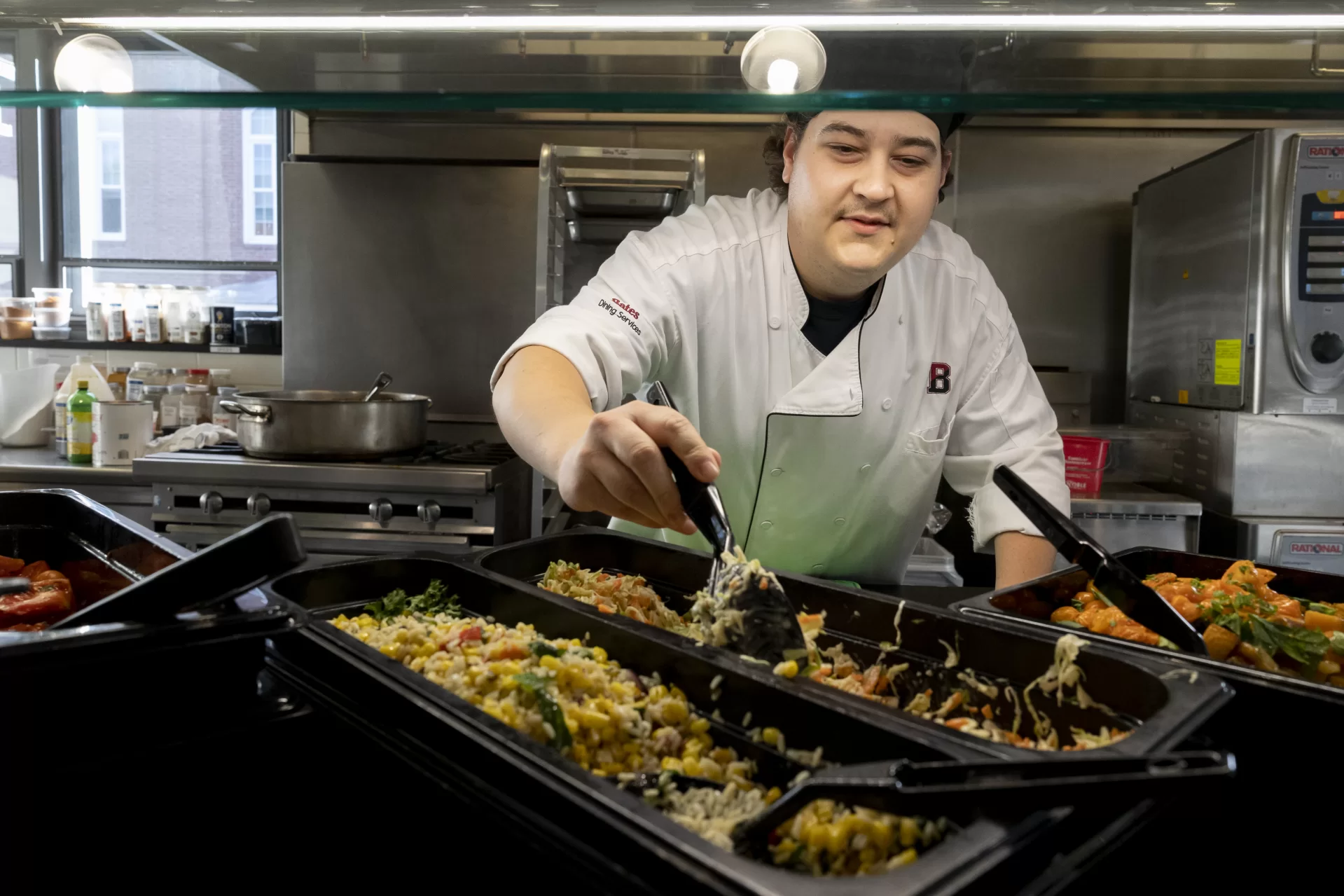 Commons at dinner hour on Thursday, Sept. 1, 2022.Christian Langlois, first cook supervisor, vegan barDishes, from left, rice, corn and spinach salad; vegan cole slaw; and butternut squash with apples and roasted tomato