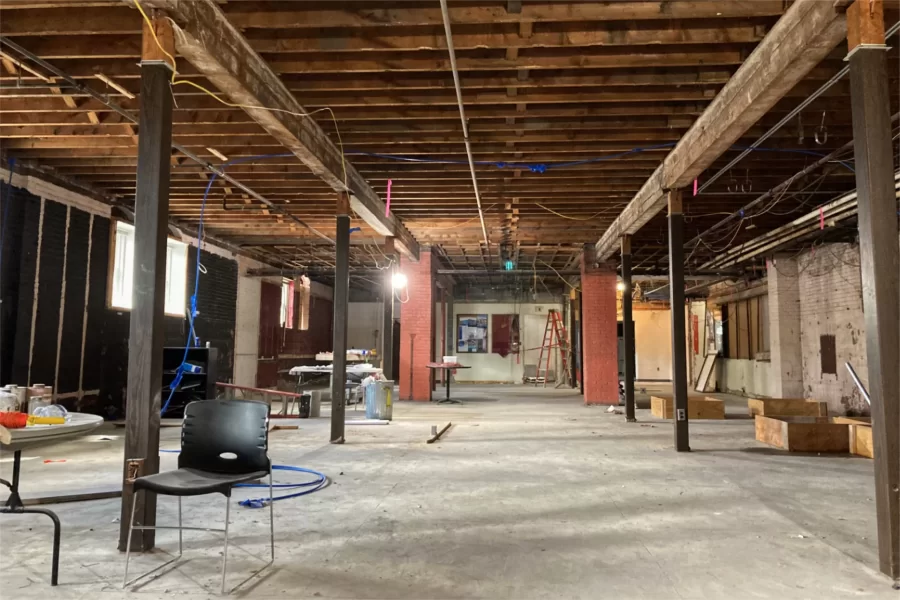 The former College Store looking toward the entrance and Chase Hall’s ground-level lobby. Between the camera and the red-brick columns, offices for Campus Life and a community service program will be placed. The space beyond the brick columns will become a student lounge. (Doug Hubley/Bates College)