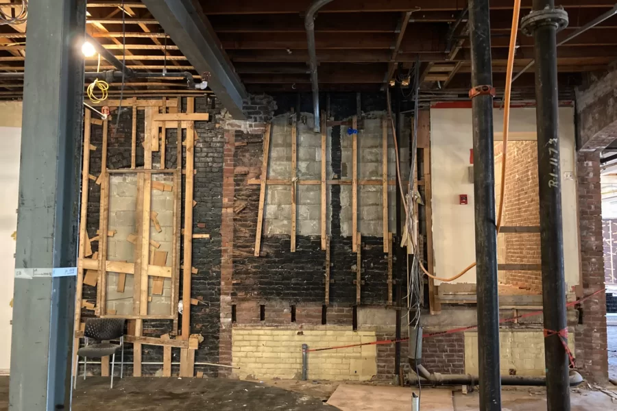 This wall in Chase Hall’s lobby will accommodate, at left behind the chair, a door leading to OIE prayer rooms and other first-floor facilities; and, at right, access to a major stairway connecting the building's three main levels. (Doug Hubley/Bates College)