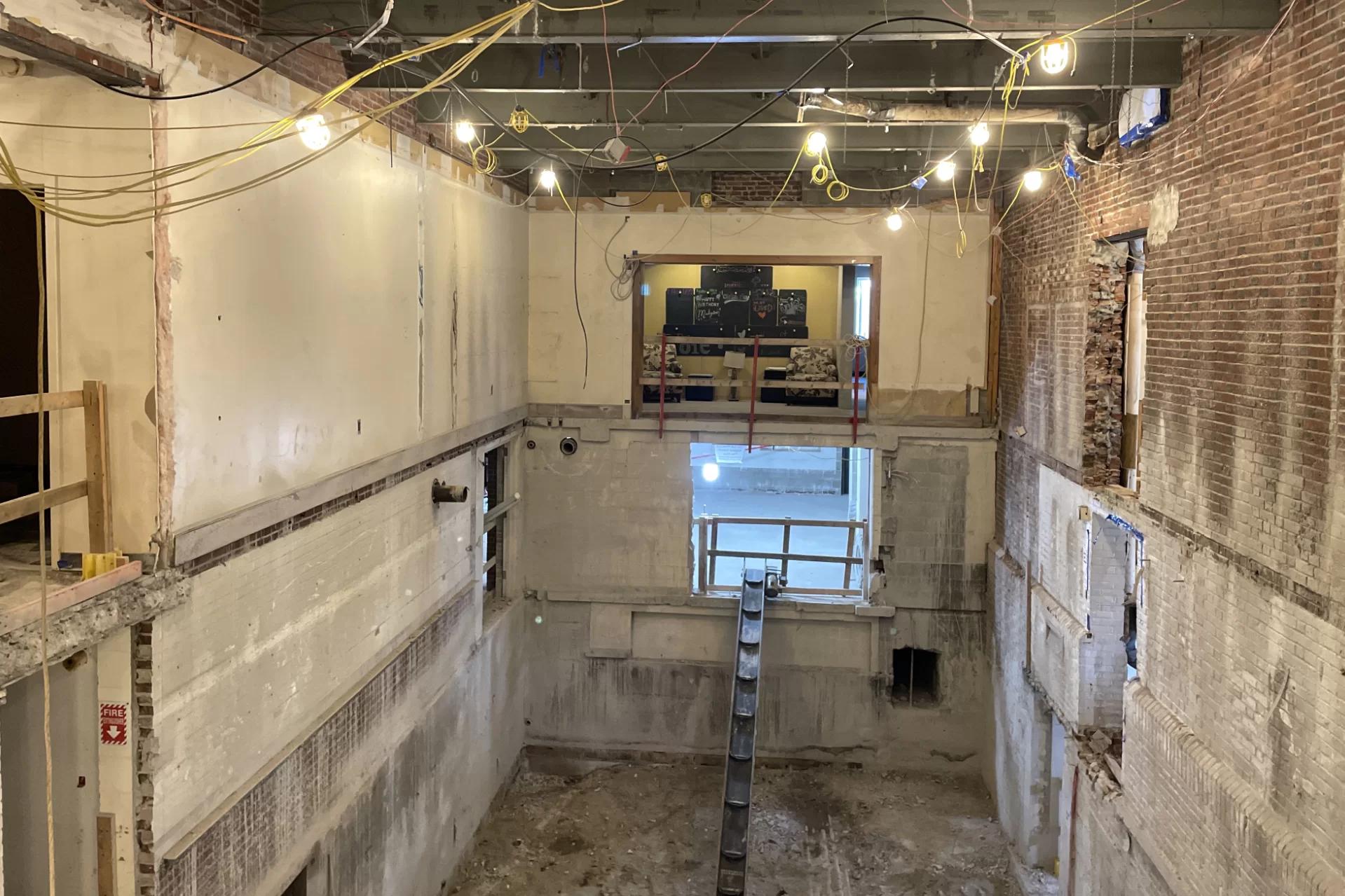 This Sept. 16 image shows the void left by the removal of two concrete floor slabs in Chase Hall. The reception area for the Office of Intercultural Education appears slightly above center. (Courtesy of Consigli Construction)