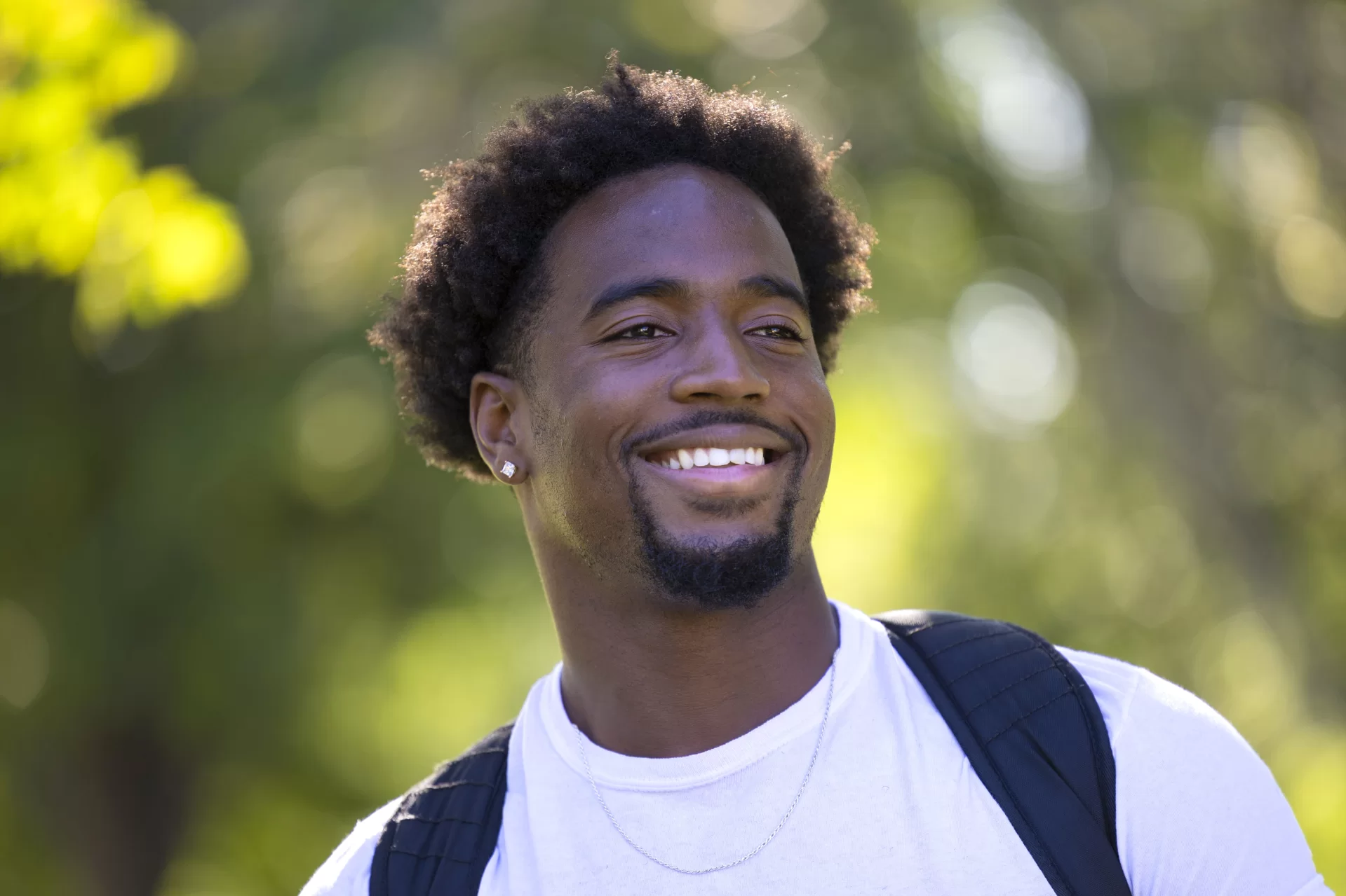 “It’s amazing being on campus again.”

— Jamil Mouehla ’25, an economics major and a mathematics minor from Harrington Park, N.J., and a running back for the football team

Stopping for a photograph on the Historic Quad, he talked about finding close friends on the team and in his classes. And he’s found extracurricular life here, too, in the Caribbean Students Association (CSA), the Black Student Union (BSU), and the Africana Club.

Today reminded him of fall. “I feel as if we’ve been getting a lot of summer. The fall is probably what makes Bates so special,” he said. “And the breeze. I love it. At home it was very hot.”

Another sign of fall: Mouehla and the Bates football team open their season Saturday at 1 p.m. against Wesleyan in Middletown, Conn.