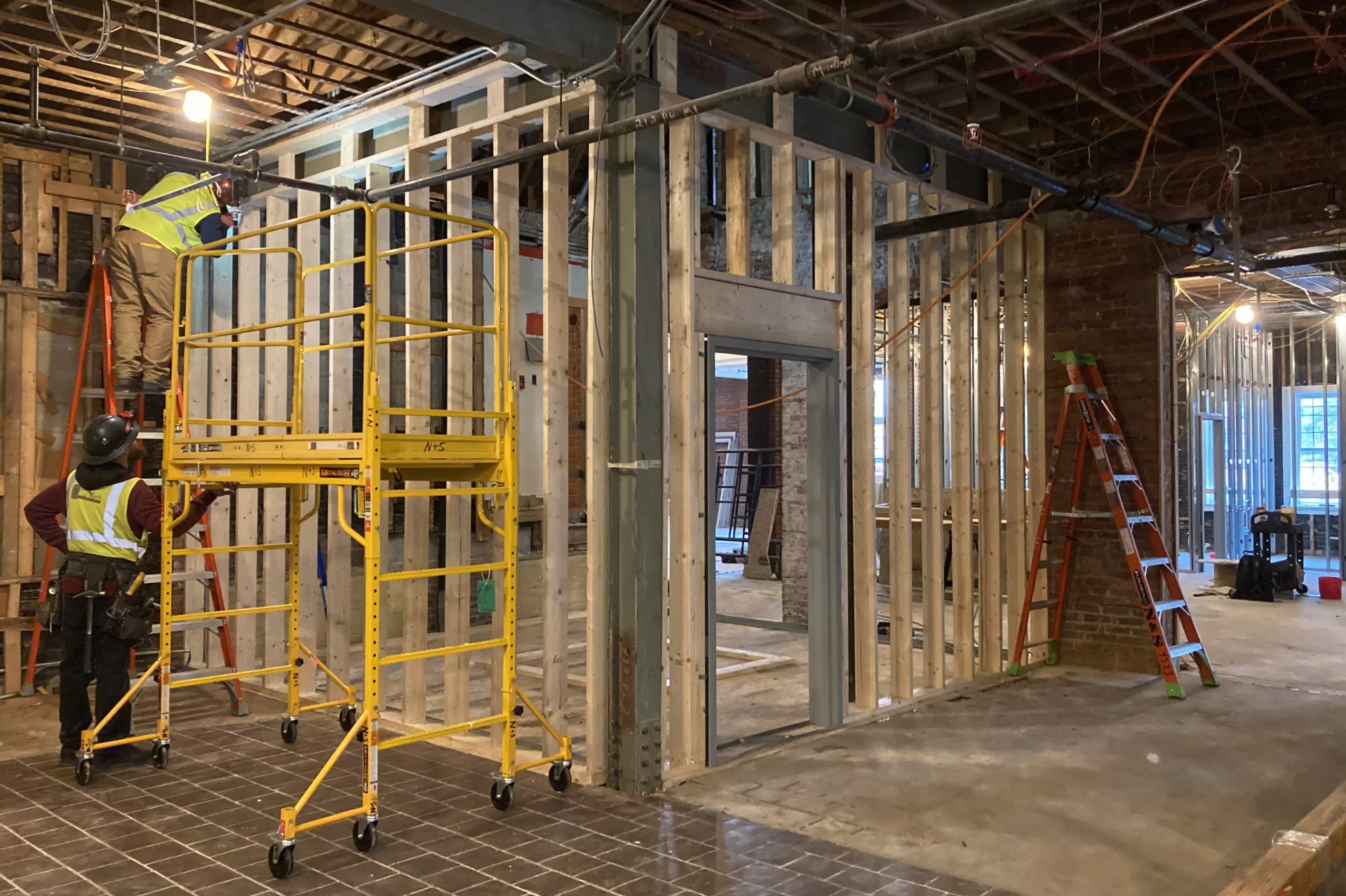 Framers create a vestibule in Chase Hall’s lobby that will enclose new stairs connecting three levels. (Doug Hubley/Bates College)