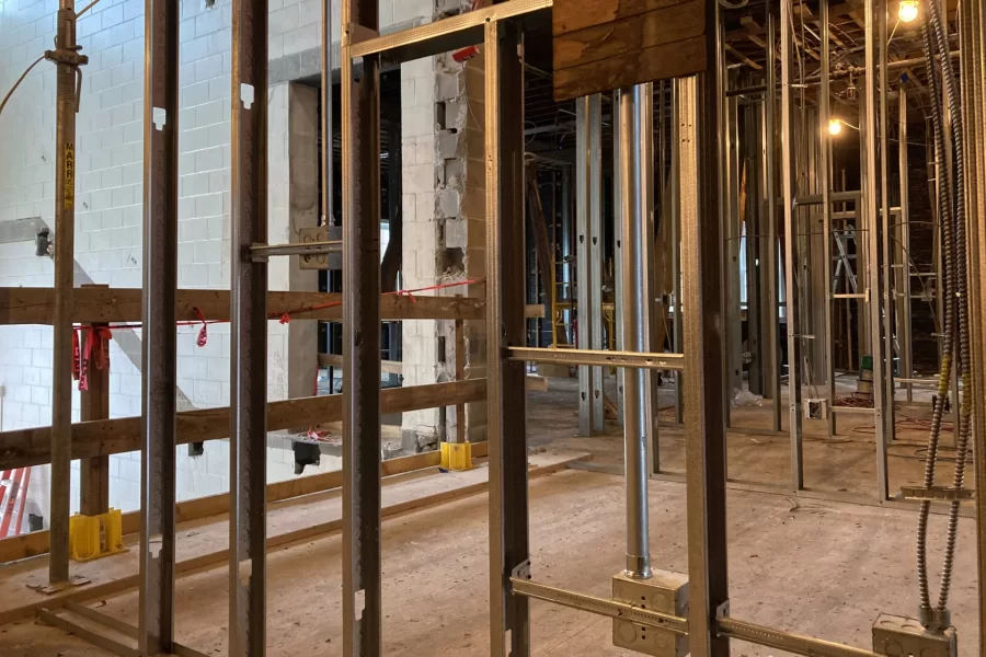 The rush is on to frame up walls in the front half of Chase Hall. Shown is what will be a warren of Purposeful Work offices and meeting rooms. At left rear is the former main staircase connecting the three floors of the original structure. (Doug Hubley/Bates College)