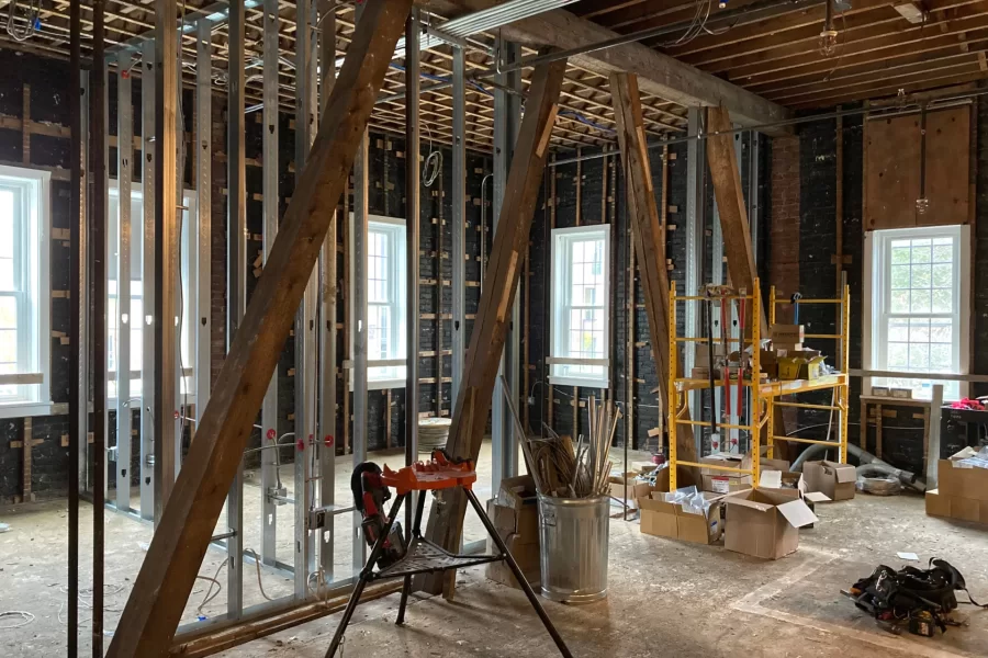 The angled wooden beams are load-bearing trusses that are original to this century-old section of Chase Hall. When the current renovation is complete, they will be partially exposed as an allusion to the building's history.