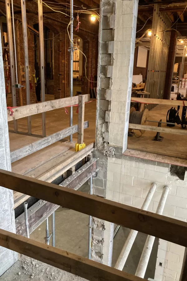 While remaining a main entrance into Chase Hall from Campus Avenue, the former stairwell near the Kenison Gate will become a sort of atrium admitting light into the building. Shown is one of two points where the floor will be extended into the atrium. The other is the next level up. (Doug Hubley/Bates College)