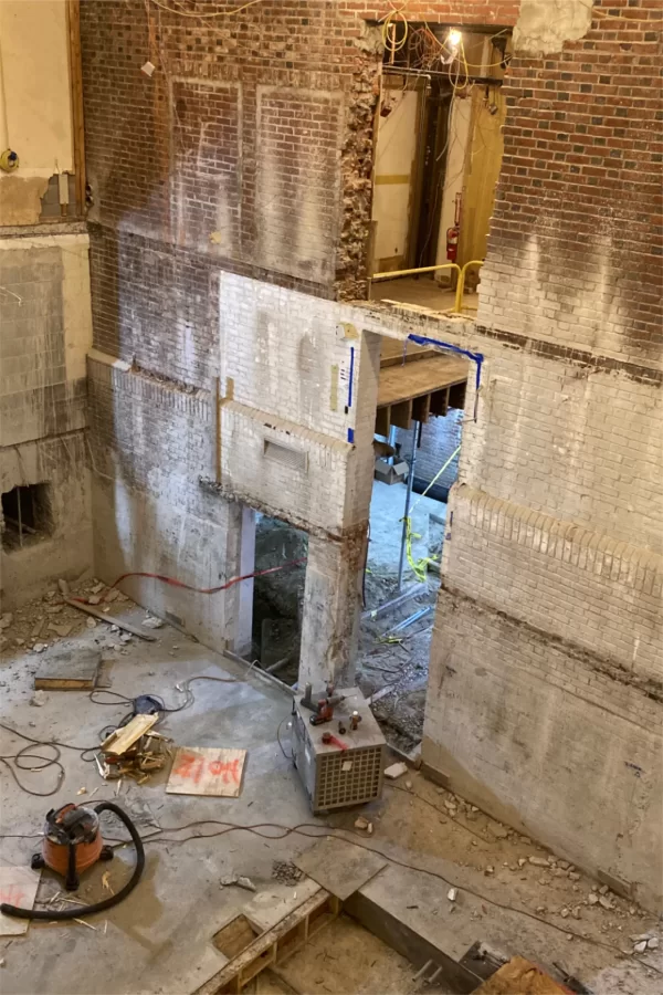 This abyss adjacent to the once and future Office of Intercultural Education (out of the frame at left) will contain a new stairway and elevator to connect the different levels of Chase Hall. (Doug Hubley/Bates College)