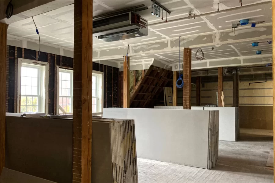 Four rooms were combined to create an open space on the second floor. Note the stockpiles of wallboard and the new HVAC infrastructure, including the boxlike fan-coil unit, on the ceiling. (Doug Hubley/Bates College)